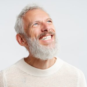 older man smiling with dental implants