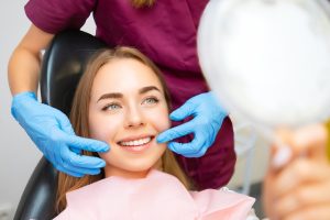 patient looking at her new smile with our dentist in North Miami Beach